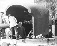 Some men preparing to instal the barrel in a 6-inch gun